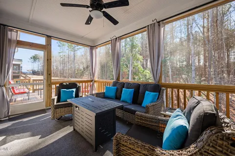 a living room with furniture and a floor to ceiling window