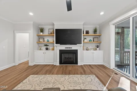 a living room with a fireplace and a flat screen tv