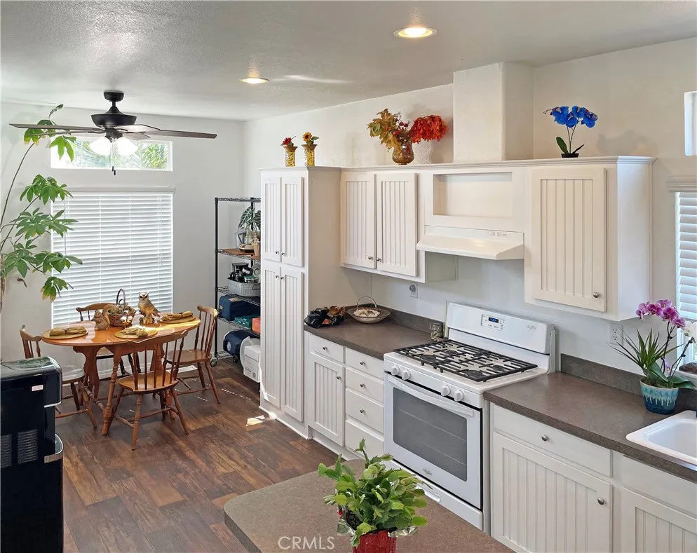 449 West Tefft Street, Unit 39 Nipomo, CA 93444 - Photo 2 of 17 a kitchen with stainless steel appliances a white table chairs and a stove