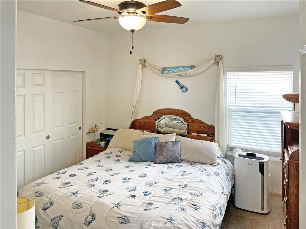 449 West Tefft Street, Unit 39 Nipomo, CA 93444 - Photo 9 of 17 a bedroom with a bed and a chandelier