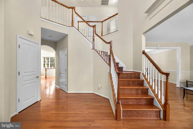 a view of entryway and hall with wooden floor
