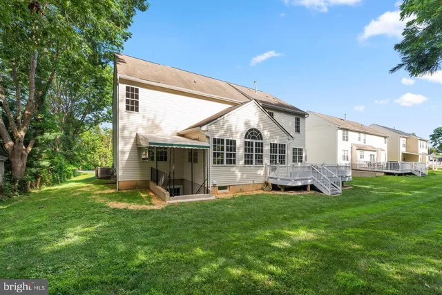 a view of a house with a yard and sitting area