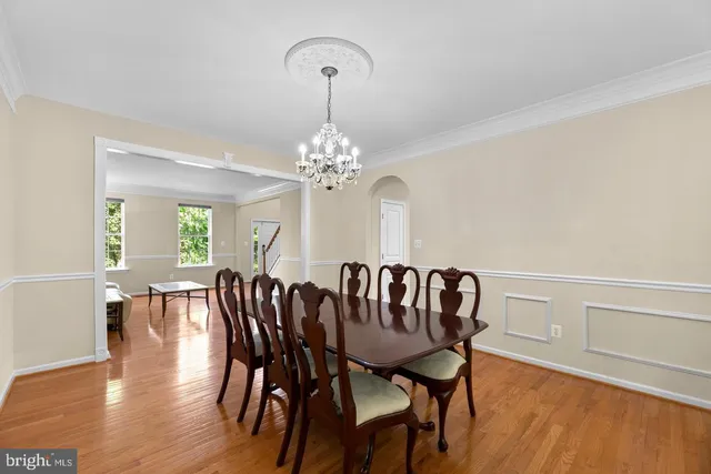 a view of a dining room with furniture wooden floor and chandelier
