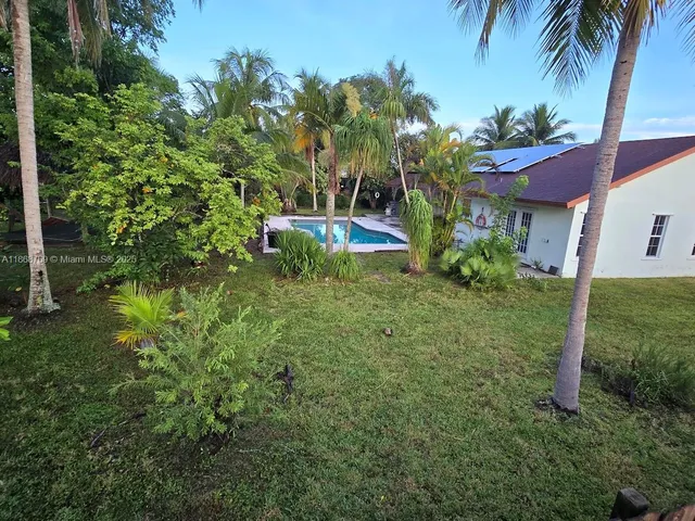 a view of a garden with a house