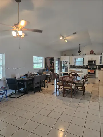 a spacious bedroom with a bed and a large window