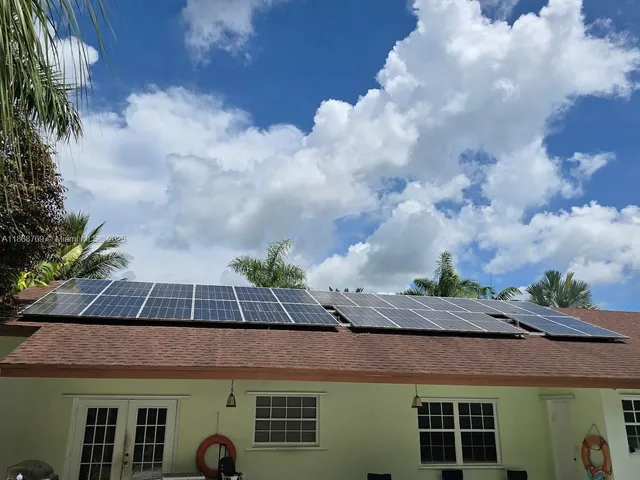 a front view of house with a garden