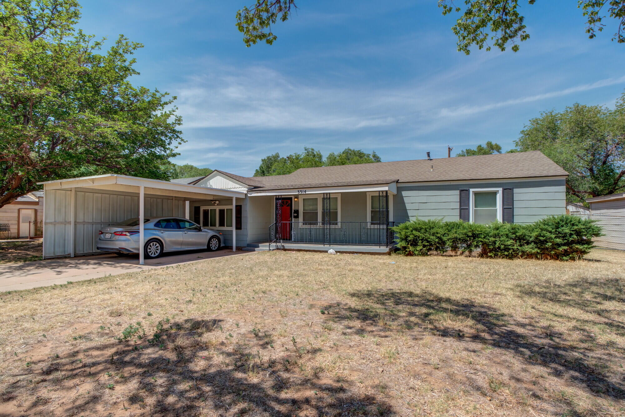 a front view of house with yard outdoor seating and barbeque oven