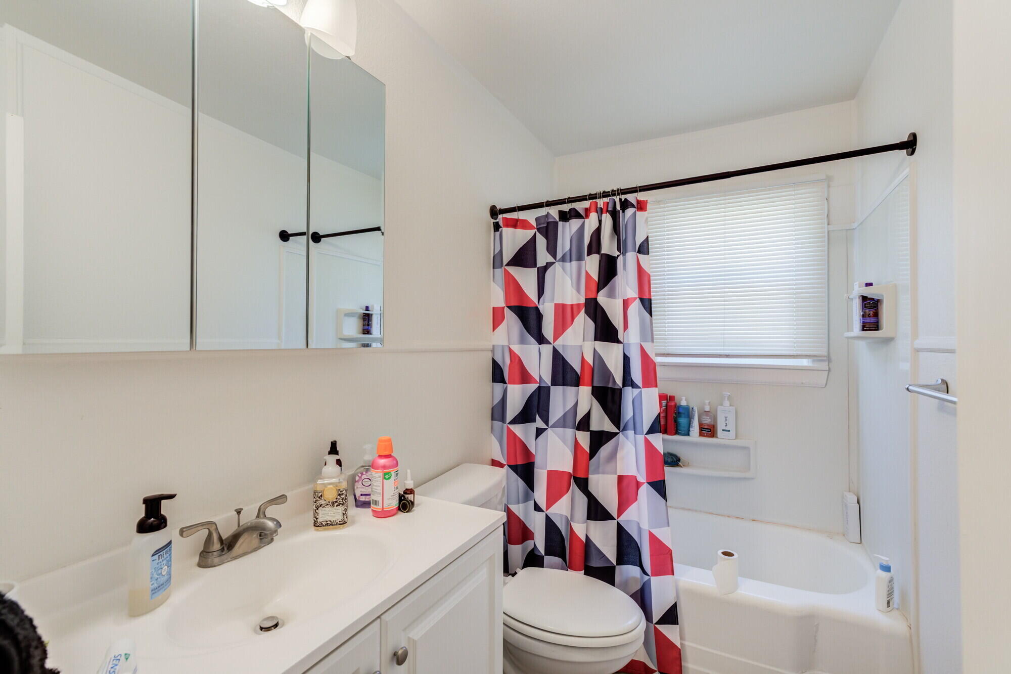 3314 31st Street Lubbock, TX 79410 - Photo 14 of 29 a bathroom with a sink a toilet and shower