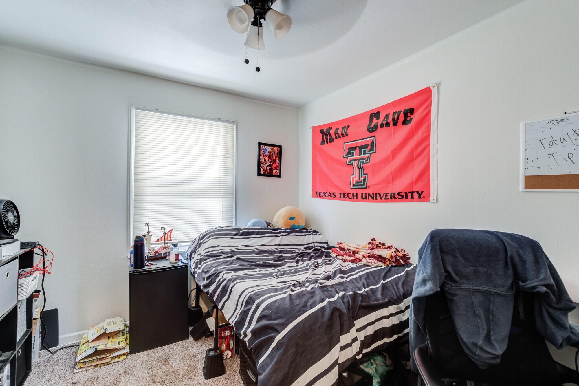 3314 31st Street Lubbock, TX 79410 - Photo 19 of 29 a bed sitting in a bedroom next to a window