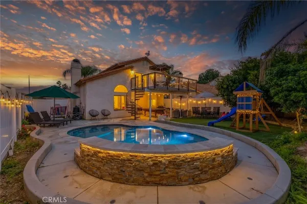 a view of swimming pool with outdoor seating and a garden