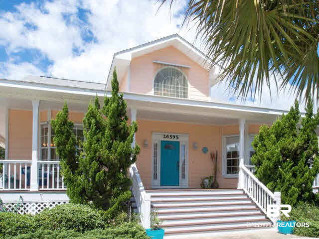 26595 Marina Road Orange Beach, AL 36561 - Photo 2 of 29 Home has wonderful wrap around porch with seating areas at every corner to catch prevailing breeze