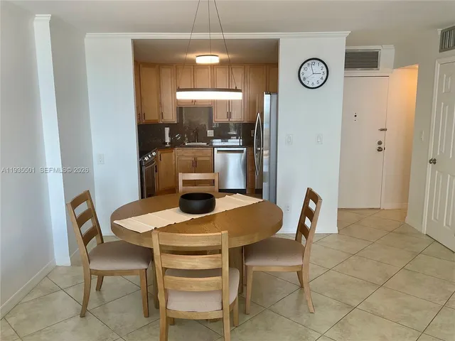 a view of a dining room with furniture and a chandelier