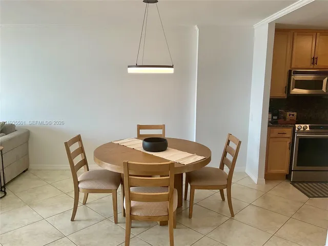 a view of a dining room that has a table and chairs