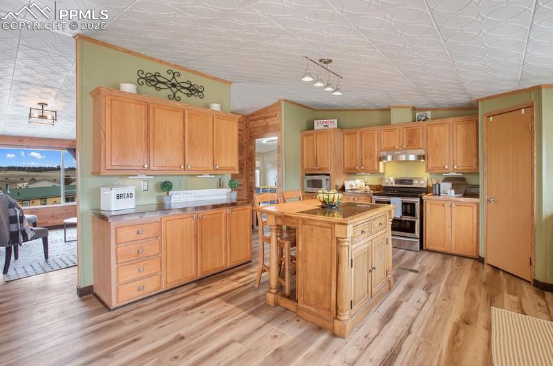 338 Doublet Lane Divide, CO 80814 - Photo 9 of 31 a kitchen with a sink window and cabinets