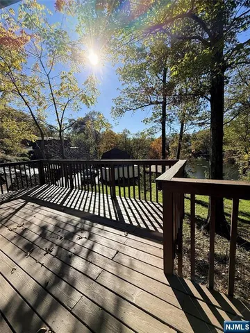 a view of a roof deck with wooden floor and fence