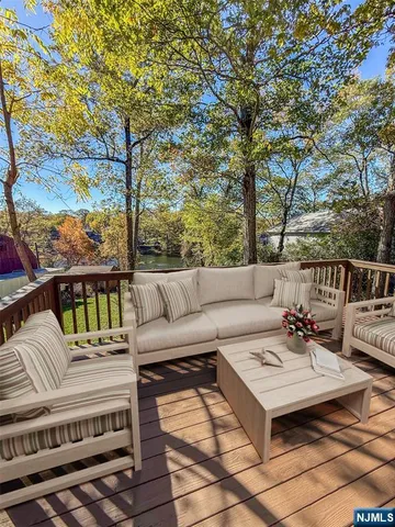 a roof deck with couches and wooden floor
