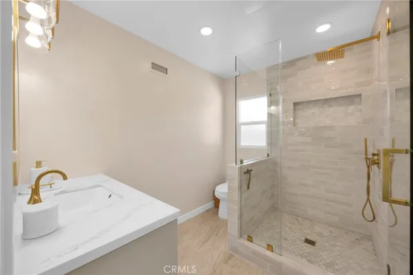 a bathroom with a shower and a sink