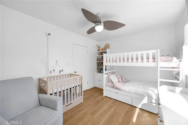 a bedroom with furniture and a wooden floor
