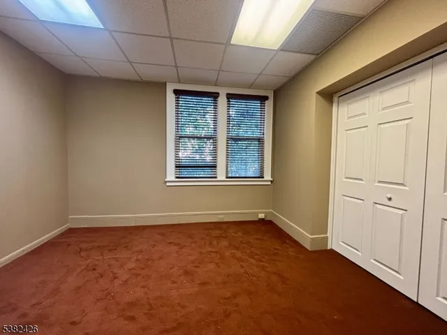 an empty room with an entryway and closet