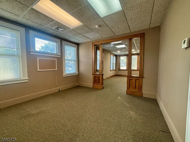 an empty room with a empty space and windows