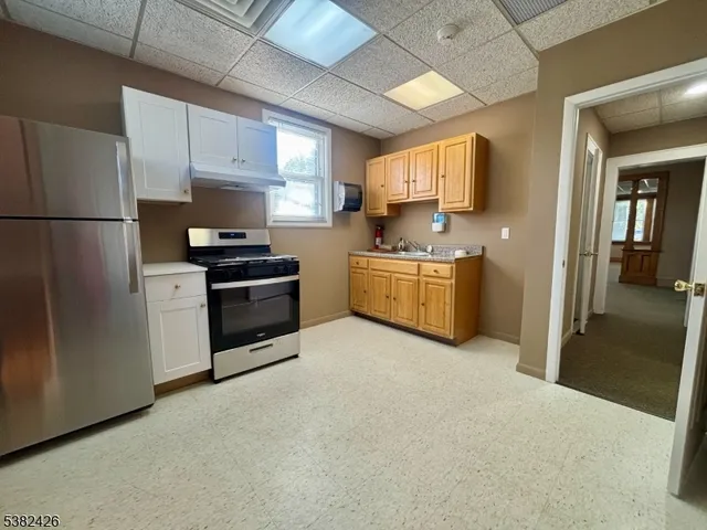 a kitchen with stainless steel appliances a refrigerator and a stove
