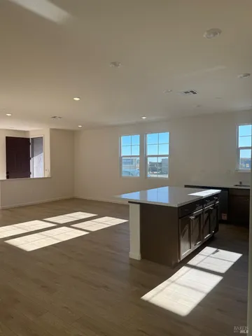 a room with wooden floors and wooden cabinets