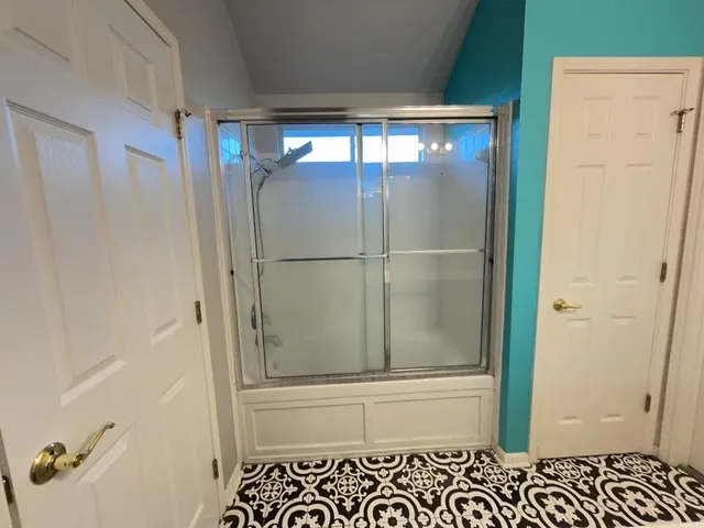 a bathroom with a glass shower door