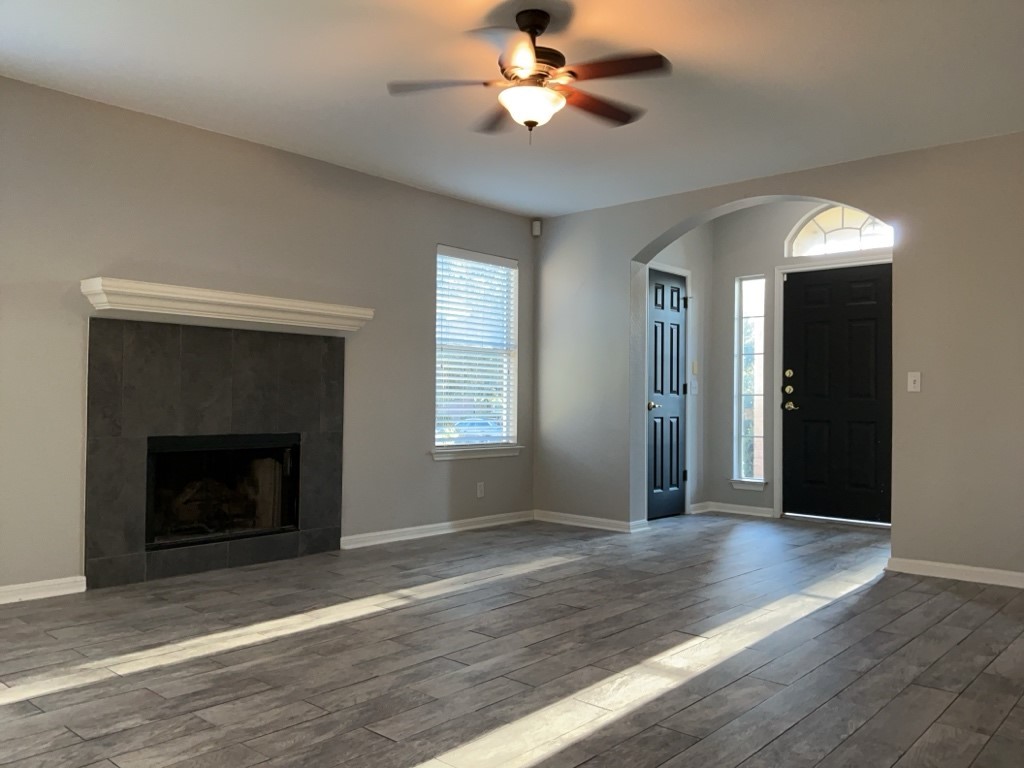 305 Avalanche Avenue Georgetown, TX 78626 - Photo 5 of 22 wooden floor fireplace and windows in an empty room