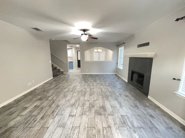 wooden floor in an empty room with a fireplace