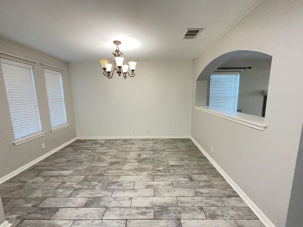 305 Avalanche Avenue Georgetown, TX 78626 - Photo 7 of 22 wooden floor in an empty room with a window