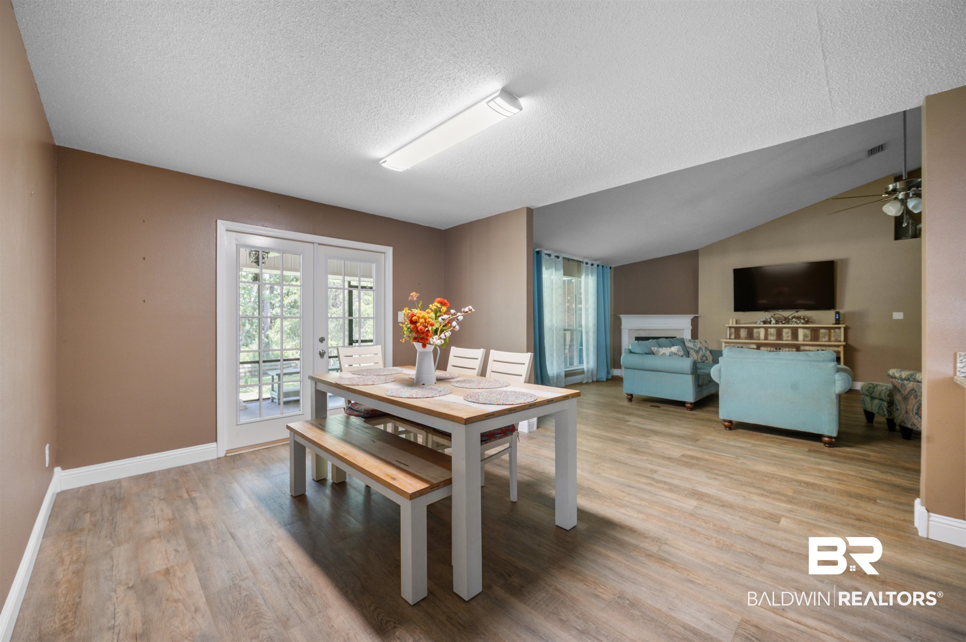 11705 Venice Boulevard Foley, AL 36535 - Photo 13 of 43 Dining room with french doors, lofted ceiling, a textured ceiling, wood-type flooring, and ceiling fan