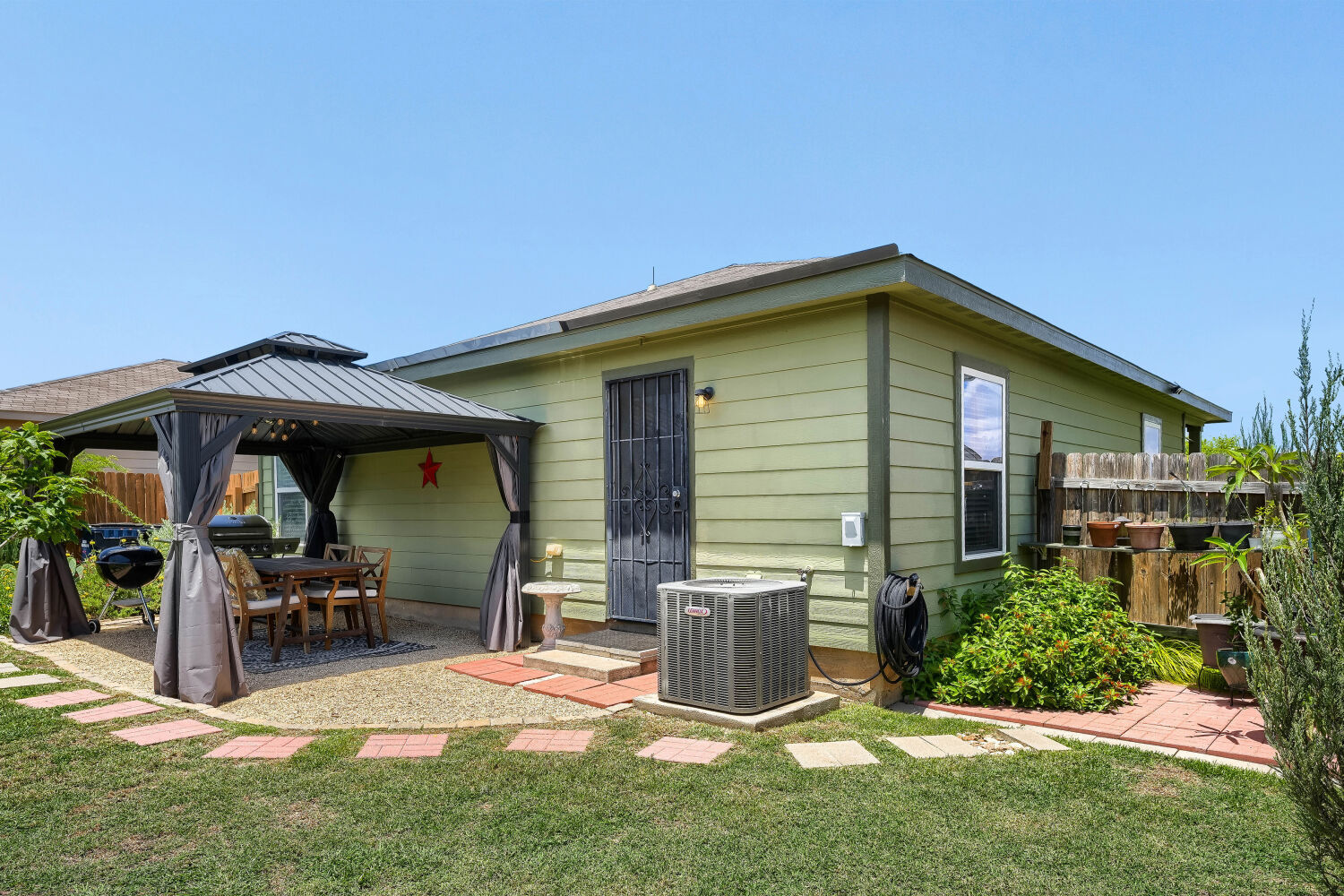116 Millers Loop Jarrell, TX 76537 - Photo 22 of 23 An inviting backyard patio with a shaded gazebo offers an ideal spot for outdoor dining and relaxation.