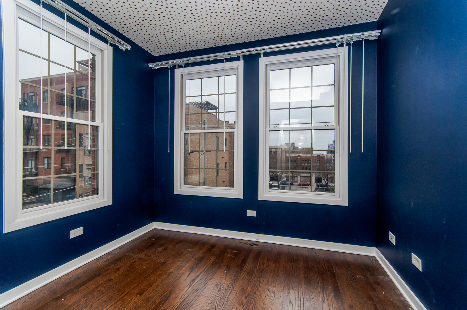 24 North Ada Street, Unit I Chicago, IL 60607 - Photo 11 of 12 a view of an empty room with a window and wooden floor
