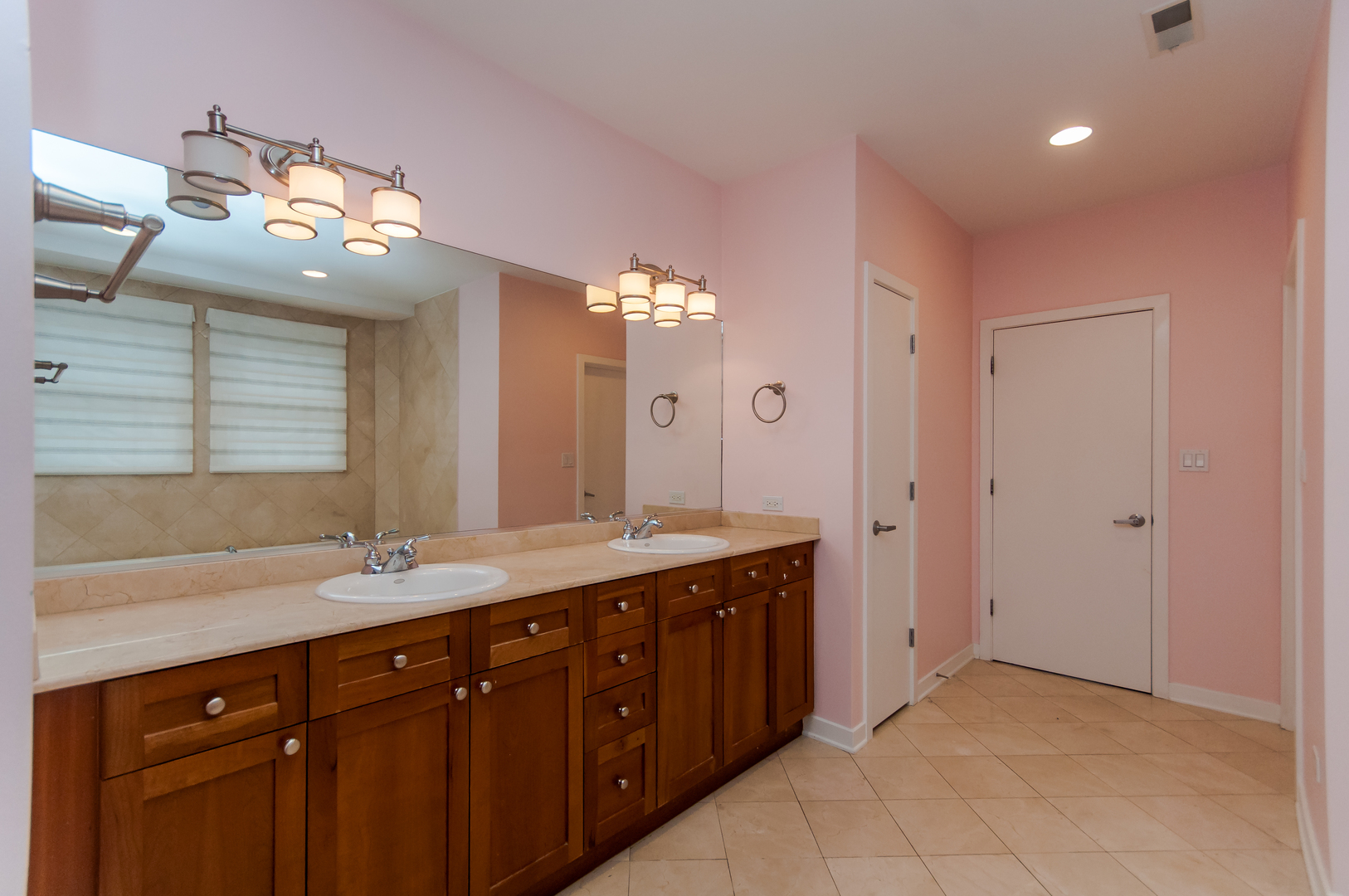 24 North Ada Street, Unit I Chicago, IL 60607 - Photo 9 of 12 a spacious bathroom with a double vanity sink and a mirror