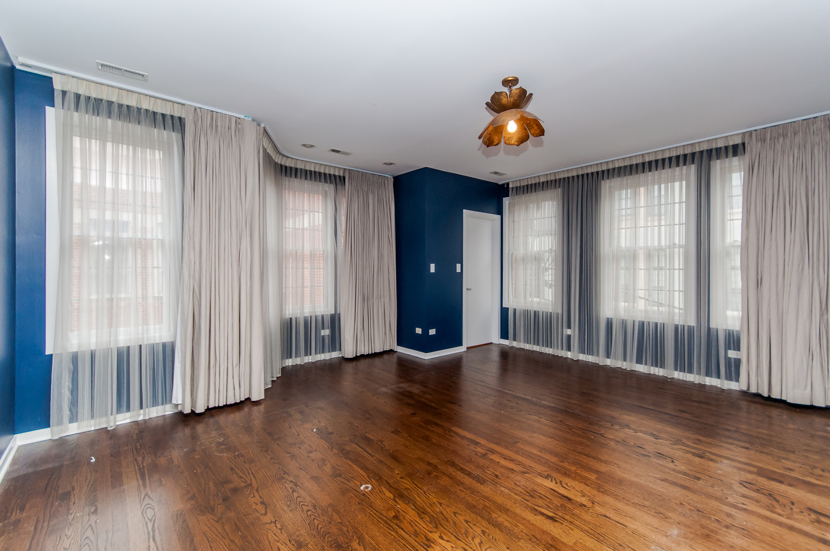 24 North Ada Street, Unit I Chicago, IL 60607 - Photo 10 of 12 an empty room with wooden floor and windows