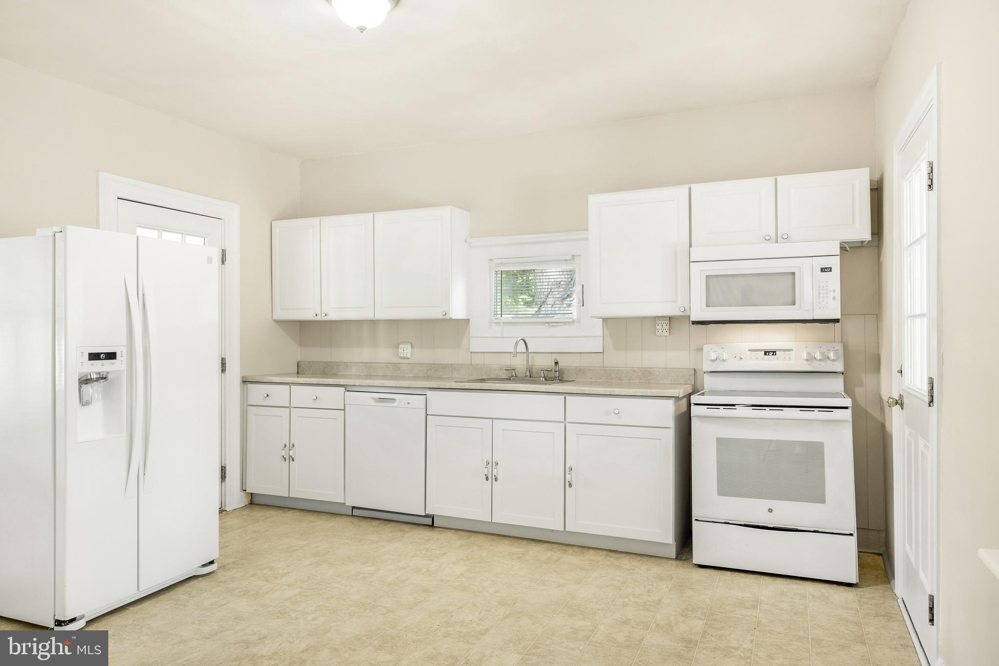 10287 Dahlgren Road King George, VA 22485 - Photo 13 of 54 a kitchen with granite countertop white cabinets white stainless steel appliances with a sink and dishwasher