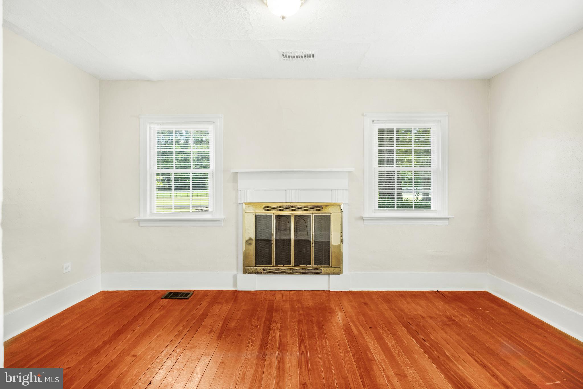 10287 Dahlgren Road King George, VA 22485 - Photo 19 of 54 an empty room with wooden floor and windows
