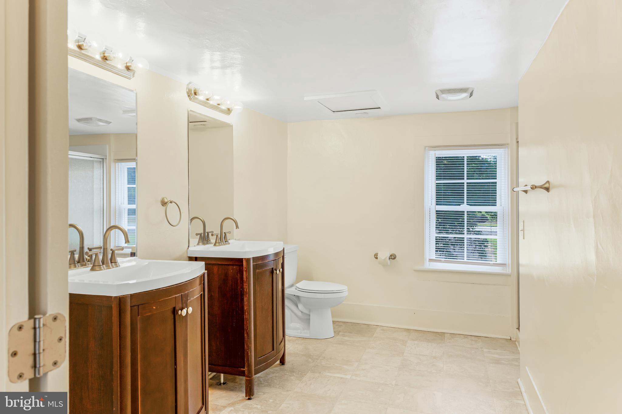 10287 Dahlgren Road King George, VA 22485 - Photo 29 of 54 a bathroom with a double vanity sink mirror and toilet