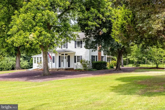 a view of a patio with table and chairs under an umbrella