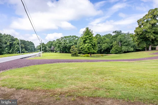 a view of a house with swimming pool and sitting area