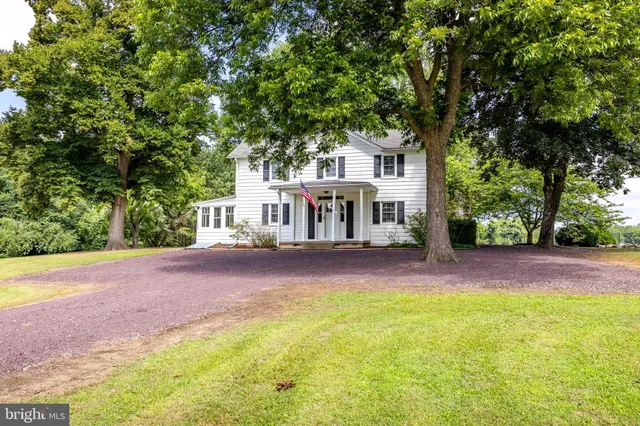a house view with swimming pool in front of it
