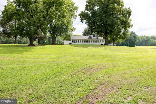 a view of a swimming pool with an outdoor space and seating area