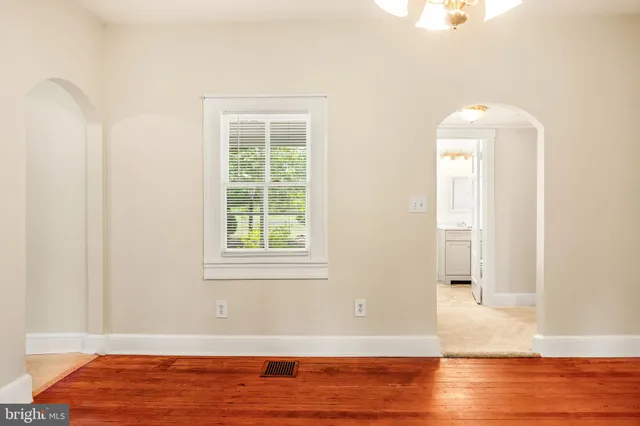 a view of a room with wooden floor