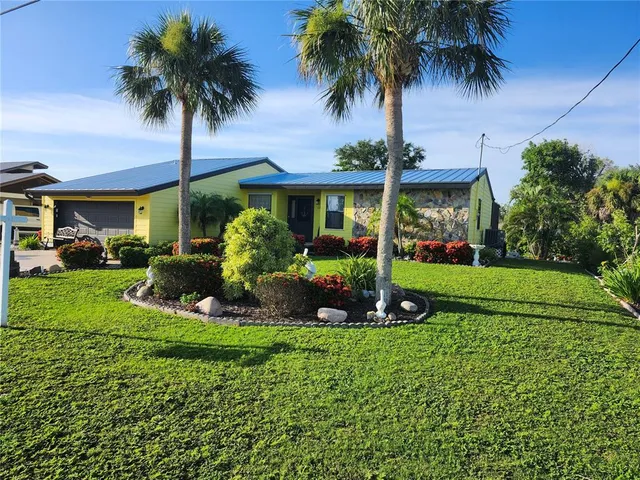 a front view of multi story residential apartment building with yard and green space