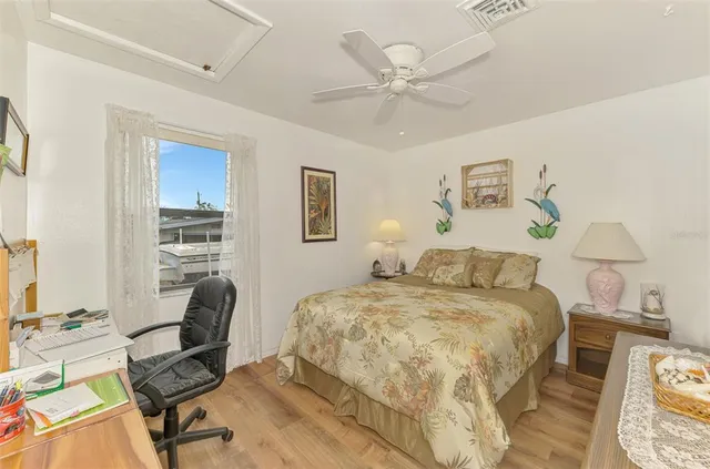 a bedroom with a bed and a desk