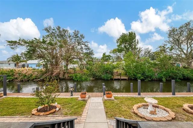 a view of a swimming pool with a patio and a yard