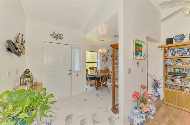 a living room with furniture and a book shelf