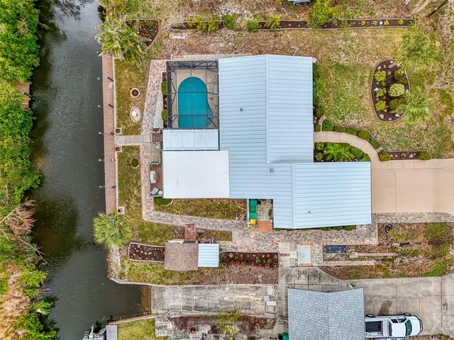 a view of a house with a big yard and potted plants