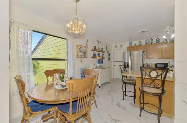 a view of a dining room with furniture and a chandelier