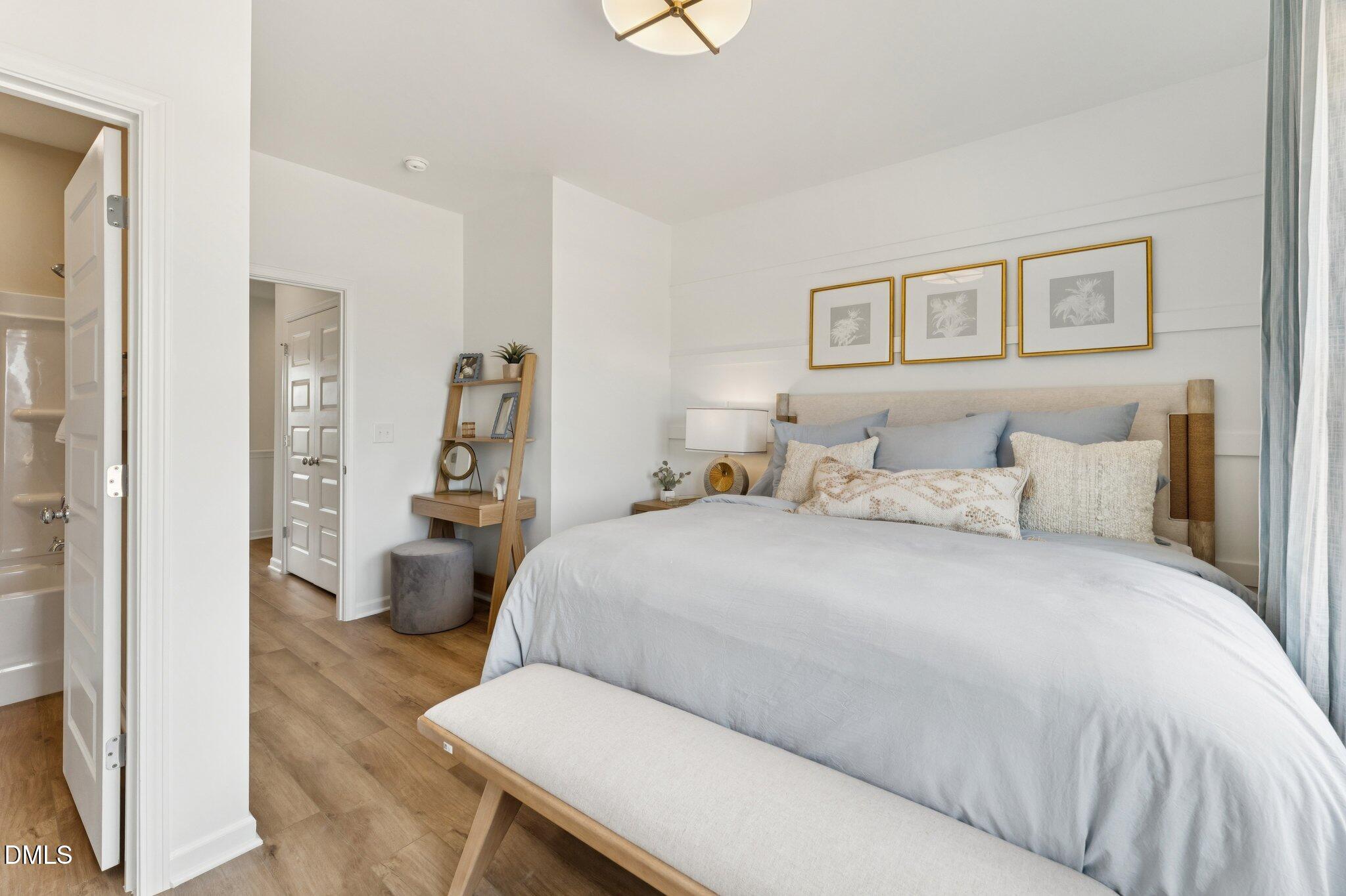 3104 Bomore Road Raleigh, NC 27610 - Photo 24 of 34 a bedroom with a large bed and a painting on the wall